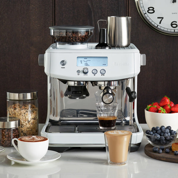 Breville Barista Pro Espresso Machine in Sea Salt White on Countertop with Lattes